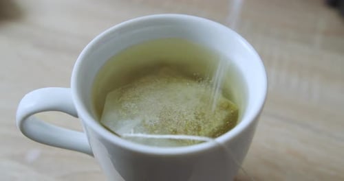 White muy with hot water and chamomile while pouring white pouring white sugar. 4K