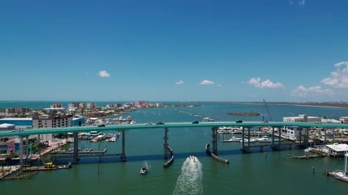 Drone shot flying over the Fort Myers Beach Bridge on a sunny day