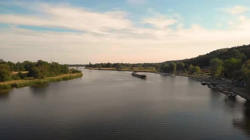 Oder River With Traveling Bulk Carrier Ship In Poland, Central Europe. Aerial Wide Shot