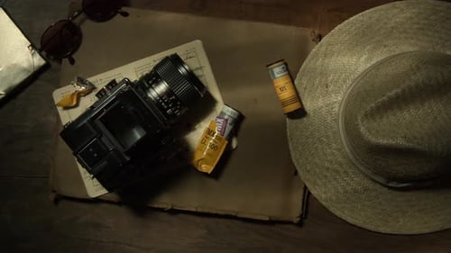 Top View of an Analogue Photography Device and a Straw Hat