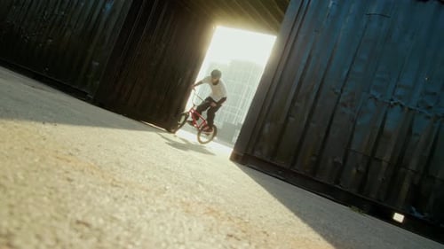 BMX Athlete Performing 360 Trick on Bike in Urban Training Area