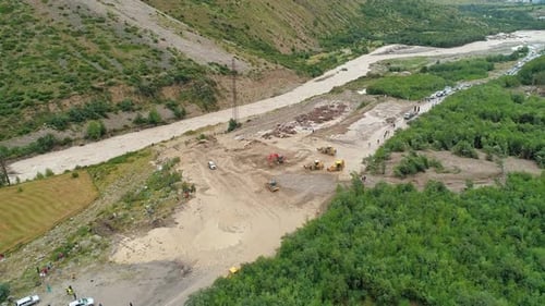 Aerial of an Excavator and Wheeled Bulldozers Removing Massive Mudflow From the Roadway Natural