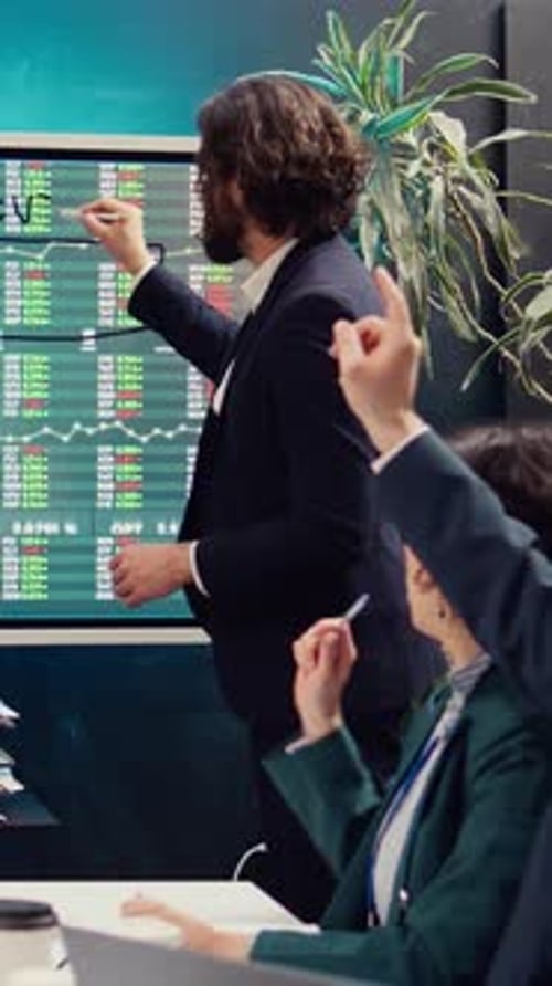 Sales Management Team Reviewing Global Stock Market Trends