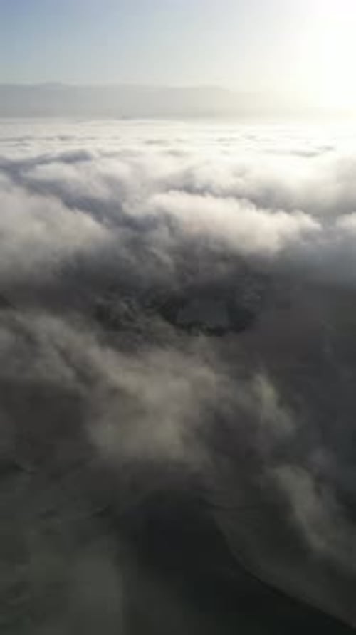 Aerial video above fog in the dunes of Huacachina Peru