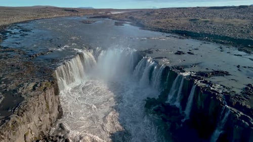 Majestic Waterfall Cascades Through Rocky Terrain, Aerial View