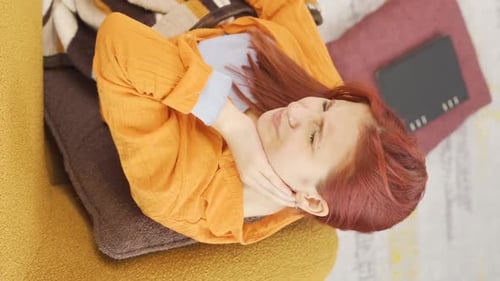 Woman Lying on Couch with Throw Pillows
