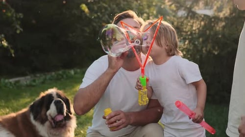 Father and Children Enjoying Bubbles with Dog