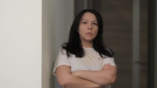 Woman Standing with Arms Crossed Looking Forward