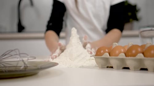 Close Up Hand Little Girl Collects White Flour From Table Child Plays and Makes Castle or Tower with