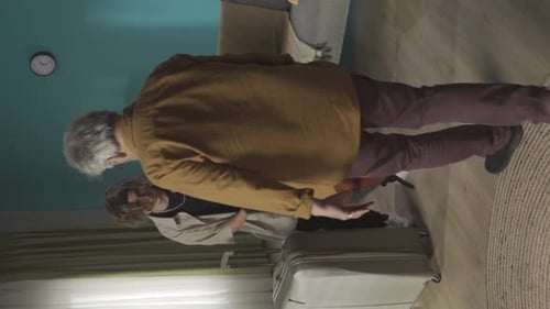Vertical Video of a Teenager Young Man with His Grandfather Granddad Posing at the Camera As If They