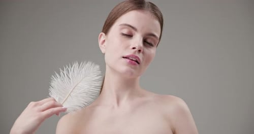 Woman Posing with White Feather