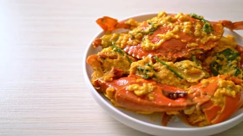 Cooked Crab Garnished with Herbs on a White Plate