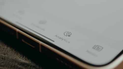 Phone Screen Displaying Analytics App on Home Screen