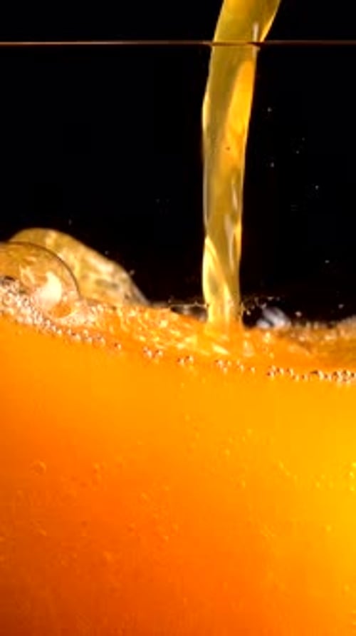 Watch Orange Juice and Soda Mix in Super Slow Motion at 1000 Fps in Clear Glass on a Black