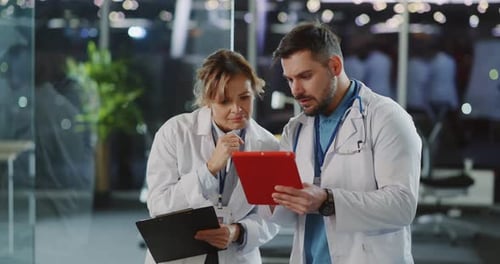 Professional Friendly Male Female Team Couple of Doctor and Nurse Communicating in Hospital Office