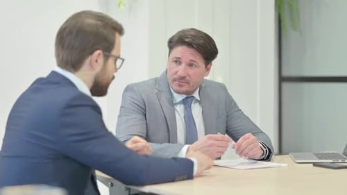 Businessman Talking with Partner in Office