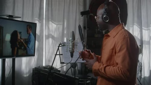Black Male Voiceover Actor Dubbing Film Scene in Recording Studio