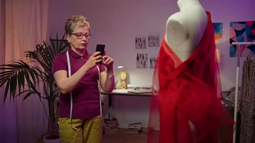 Fashion Designer Taking Photo of Design on Mannequin