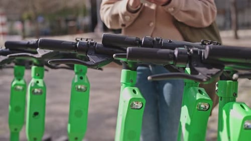 Woman Rents Electric Scooter Using Smartphone