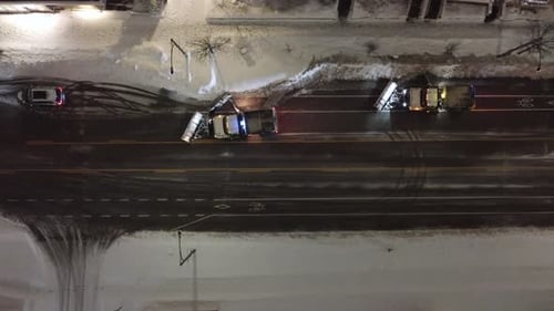 Snowplows clearing snow at night in Mississauga, Ontario