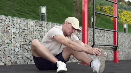 Blond Haired Man Stretching Leg Outdoors