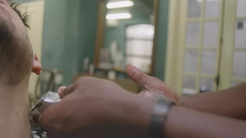 Barber Shapes Beard of Customer in Barber Shop