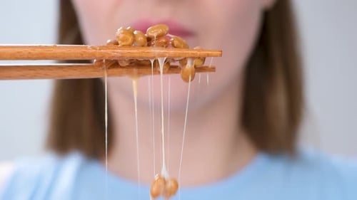 Woman Eats Natto with Chopsticks, Close-Up