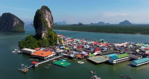 Floating Fishing Village of Koh Panyee With Pier And Limestone Island In Summer In Phang Nga Bay,