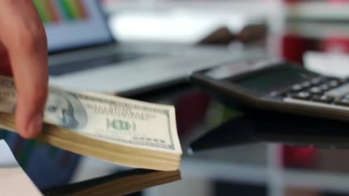 Hand Giving Dollar Bills On Office Table. Bank Offers Instant Money Transfer. Simple Financial Tr...