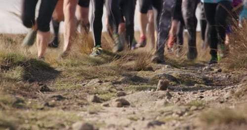 Runners' Legs and Feet on Rocky Trail