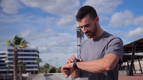 Man Checking Smartwatch in Urban Setting