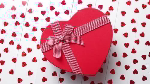 Heart Shaped Gift Box Surrounded by Confetti Hearts