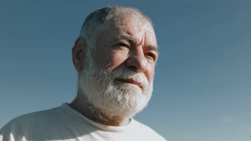 Senior Man Portrait Against Clear Blue Sky