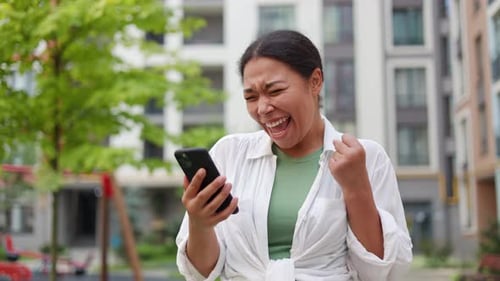 Lady Celebrate Good News From the Phone Outdoor Office Building