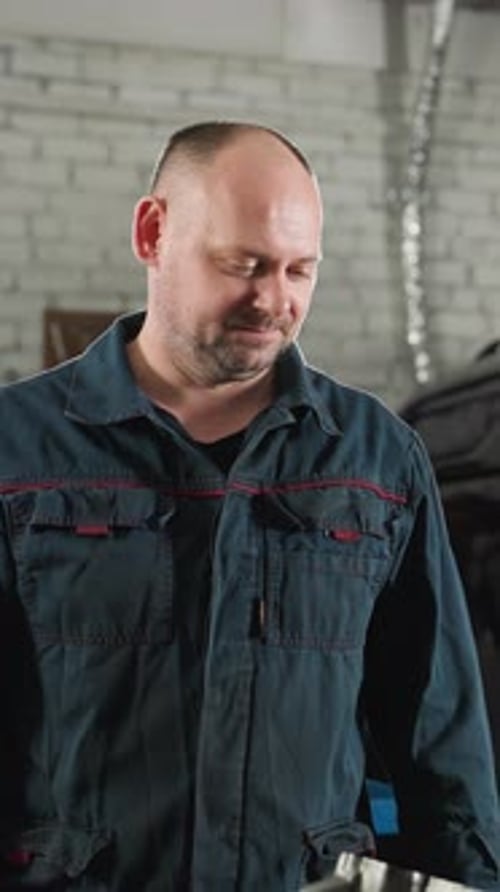 Engineers Repairing Car Engine in Workshop with Tools and Vehicles
