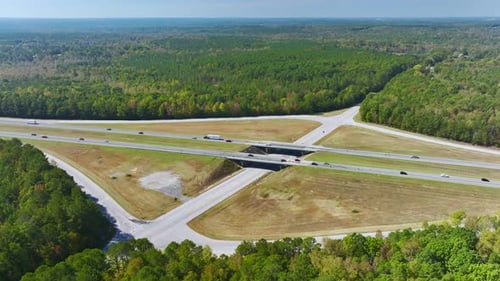 Aerial View of Freeway Overpass Junction with Fast Moving Traffic Cars and Trucks in American Rural