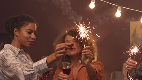 Friends Celebrating Together with Sparklers and Wine