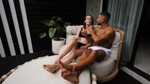 Couple Eating Grapes on Outdoor Lounge Chair