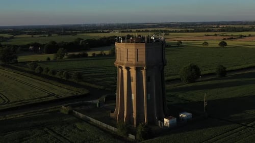 Aerial footage of a water tower on a summers evening