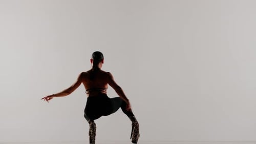 Portrait of Female Model Appealing Young Woman Dancing in Glasses and High Heels in the Studio