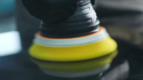 Macro Shot Of Yellow Sponge Head Of Polisher Machine Removing Scratches From Car Hood