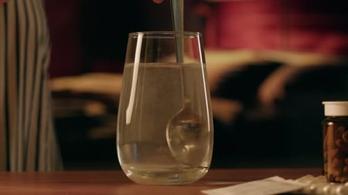 Stirring Medicine Powder in a Glass of Water