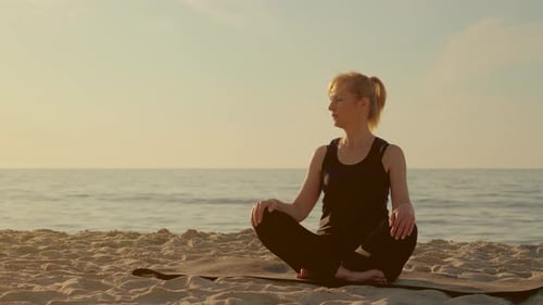 Focused Woman Practicing Meditation on Sandy Beach Summer Evening Yoga Woman Sitting Lotus Position