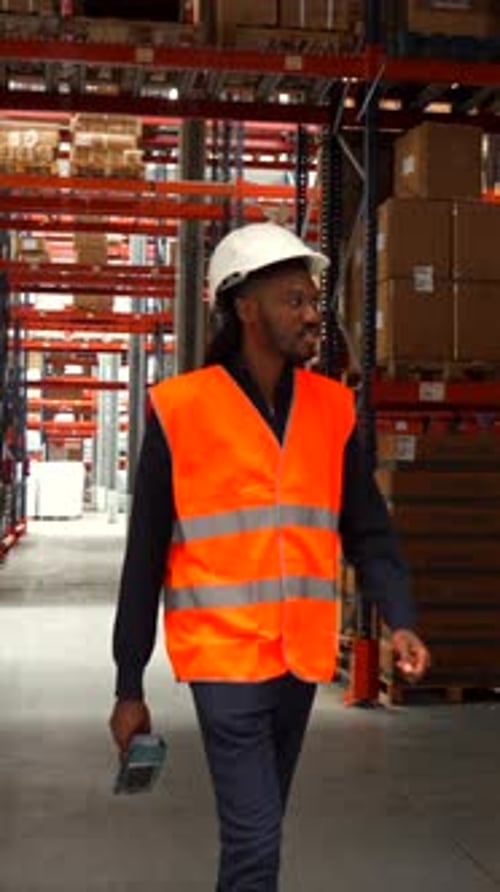 Logistics Operator Walking Through Warehouse