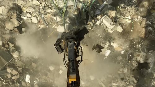 Building demolition excavator using Pulverizer Jaws to demolish a residential building