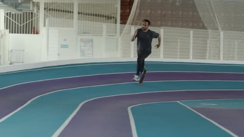 Man With Prosthetic Leg Jogs on Indoor Track