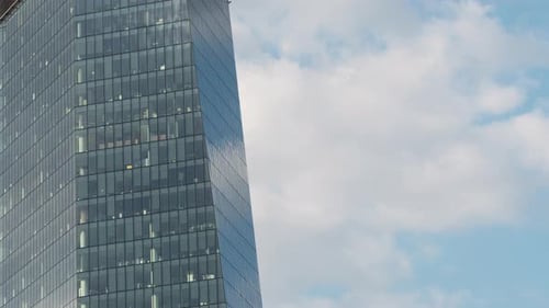 Timelapse High Rise Glass Skyscraper Office Building Facade Moving Blue Sky and Clouds Windows Glass