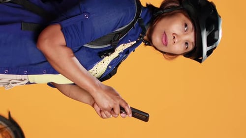 Woman with Bicycle Helmet Using Smartphone