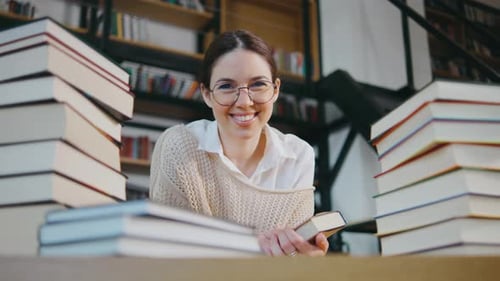 Portrait of Young Woman Student or Businesswoman Reading in the Library Students in a Good Mood