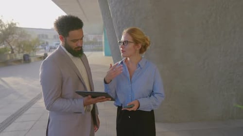 Business Colleagues Discussing Tablet Outdoors